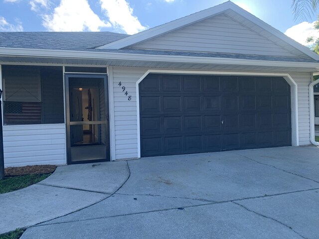 4948 SE 44th St, Okeechobee, FL 34974 - exterior space with a garage, a shingled roof, and concrete driveway