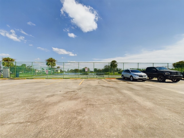 4948 SE 44th St, Okeechobee, FL 34974 - uncovered parking lot featuring fence and a tennis court