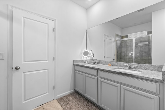 bathroom with tile patterned flooring, vanity, and a shower with shower door