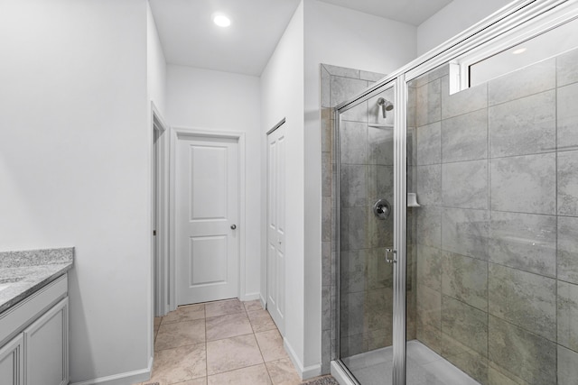 bathroom featuring tile patterned floors, vanity, and an enclosed shower