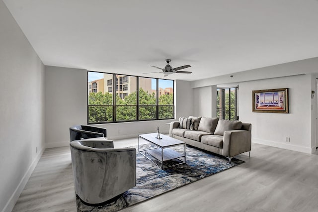 living room with hardwood / wood-style flooring and ceiling fan