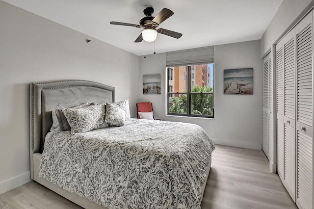 bedroom featuring a closet, light wood-type flooring, and ceiling fan