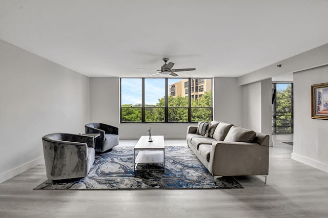 living room featuring light hardwood / wood-style flooring and ceiling fan