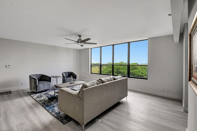 living room featuring ceiling fan and light wood-type flooring