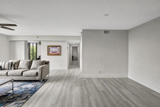 living room featuring light hardwood / wood-style flooring and ceiling fan