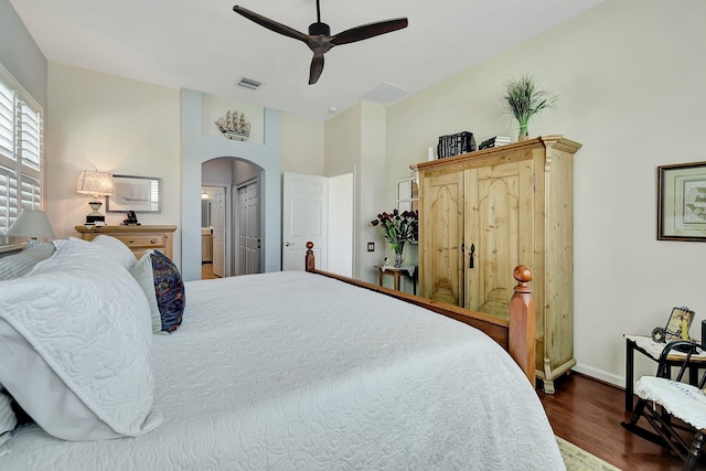 bedroom with a closet, dark hardwood / wood-style floors, ensuite bathroom, and ceiling fan