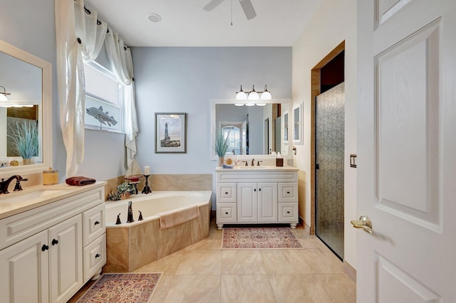 bathroom with vanity, ceiling fan, tile patterned flooring, and plus walk in shower