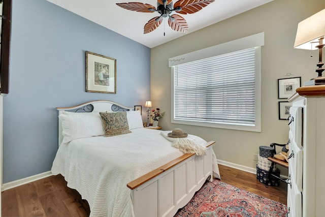 bedroom with ceiling fan and dark hardwood / wood-style flooring