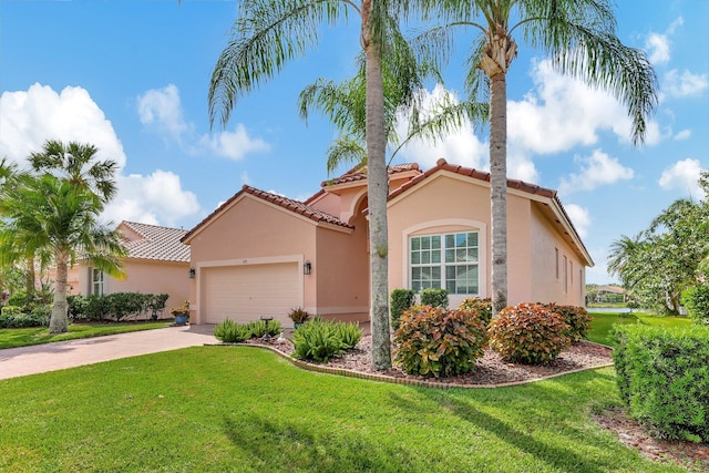 mediterranean / spanish home with a front yard and a garage