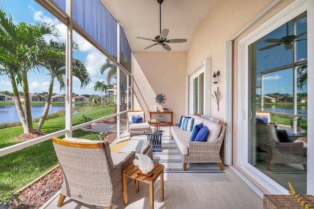 sunroom with a water view and ceiling fan