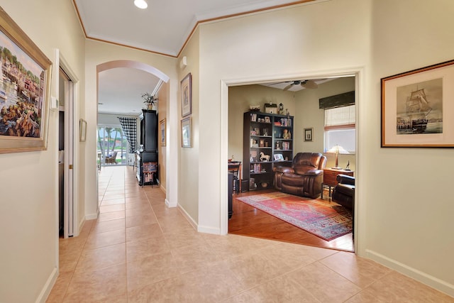 hallway featuring crown molding and light wood-type flooring