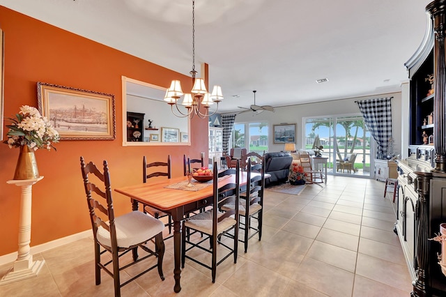 dining space with light tile patterned flooring and ceiling fan with notable chandelier