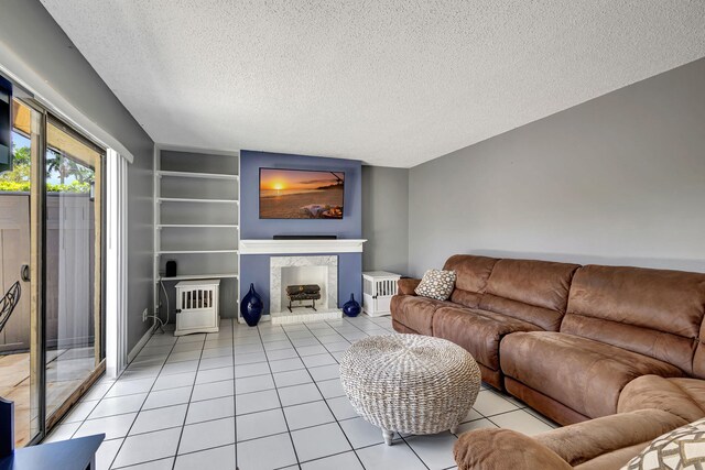 living room featuring a textured ceiling, tile patterned floors, and ceiling fan