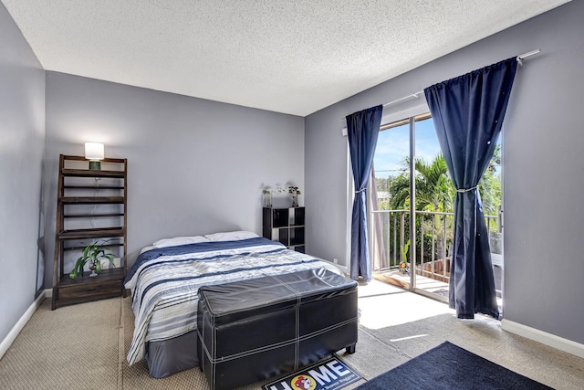 bedroom with a textured ceiling, light carpet, and access to outside