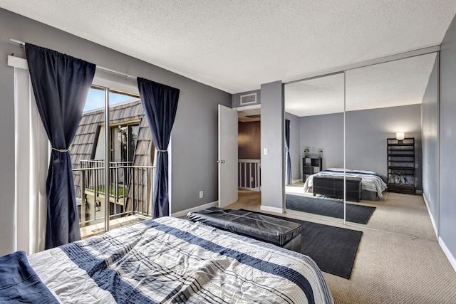 bedroom with carpet floors, access to outside, a textured ceiling, and a closet