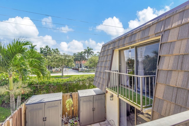 balcony featuring a storage shed