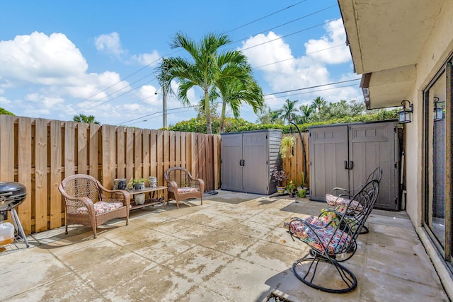 view of patio featuring area for grilling and a storage shed