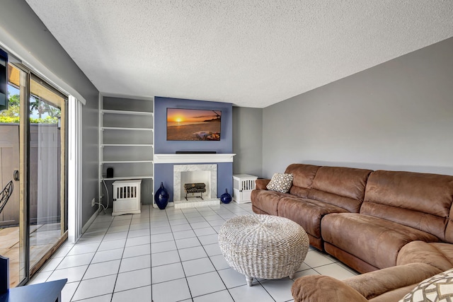 tiled living room featuring built in features and a textured ceiling