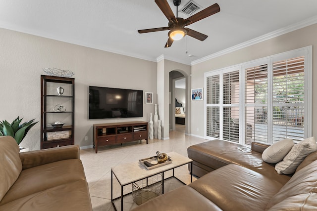 tiled living room with ceiling fan and ornamental molding