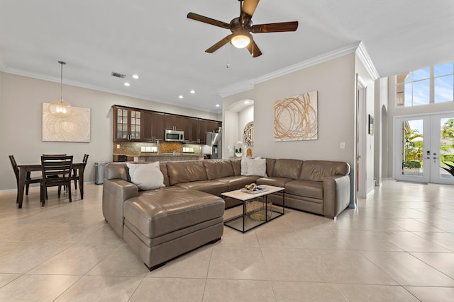 living room featuring crown molding, french doors, light tile patterned floors, and ceiling fan