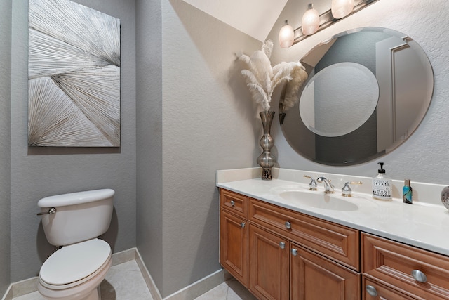 bathroom featuring toilet, vanity, and tile patterned floors