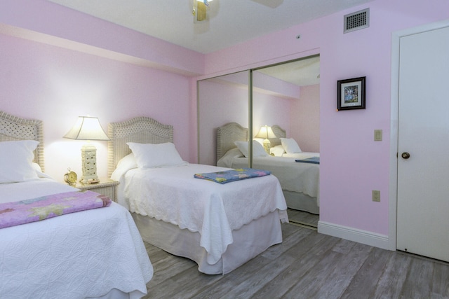 bedroom featuring hardwood / wood-style floors, ceiling fan, and a closet