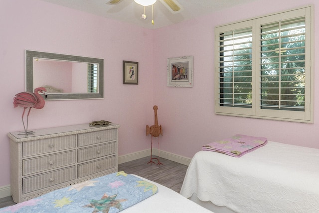 bedroom with hardwood / wood-style flooring and ceiling fan