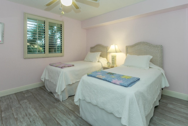 bedroom with hardwood / wood-style flooring and ceiling fan