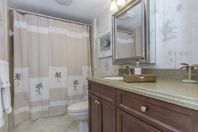 bathroom featuring tile patterned floors, vanity, and toilet