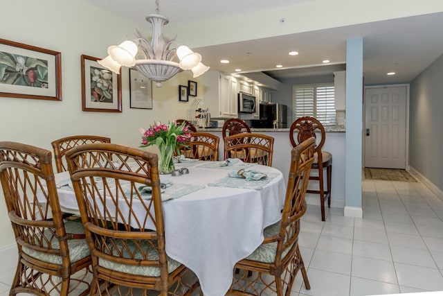 tiled dining area with a chandelier