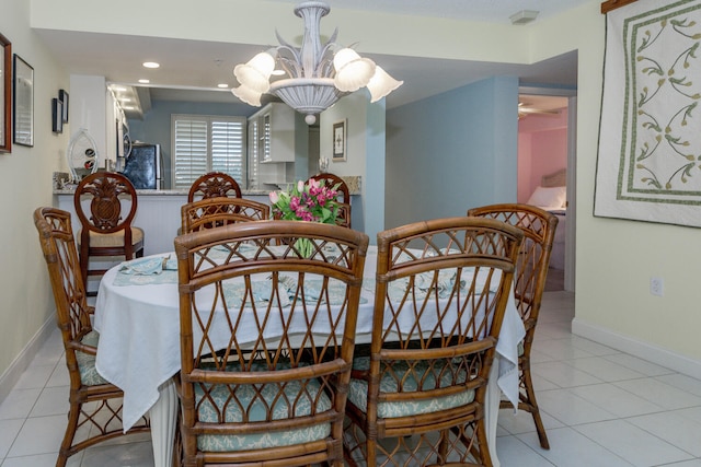 dining space featuring light tile patterned floors and an inviting chandelier