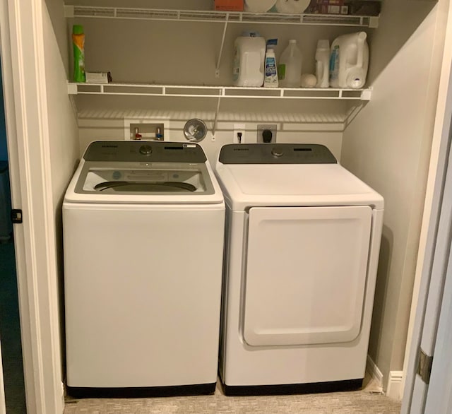 washroom with washing machine and clothes dryer