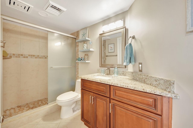 bathroom featuring toilet, vanity, tile patterned floors, and walk in shower