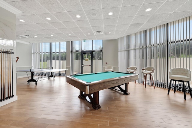 playroom featuring a wall of windows, light hardwood / wood-style floors, a drop ceiling, and billiards