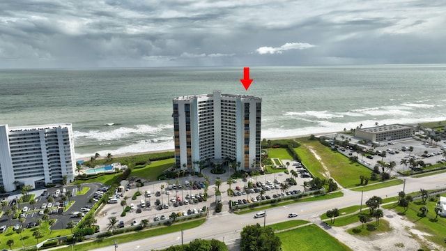 drone / aerial view featuring a water view and a view of the beach