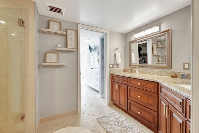 bathroom featuring tile patterned floors, vanity, and walk in shower