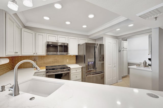 kitchen with black appliances, sink, ornamental molding, light tile patterned floors, and tasteful backsplash