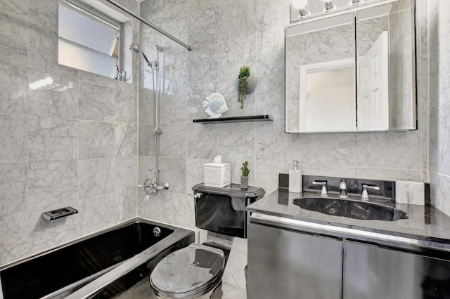 bathroom with vanity, tile walls, and tiled shower / bath