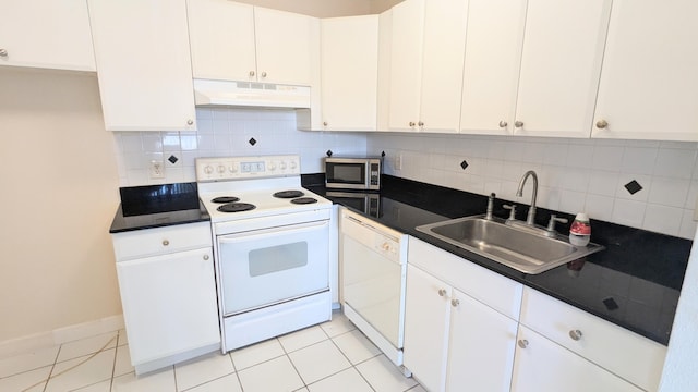 kitchen featuring sink, tasteful backsplash, white appliances, and white cabinetry