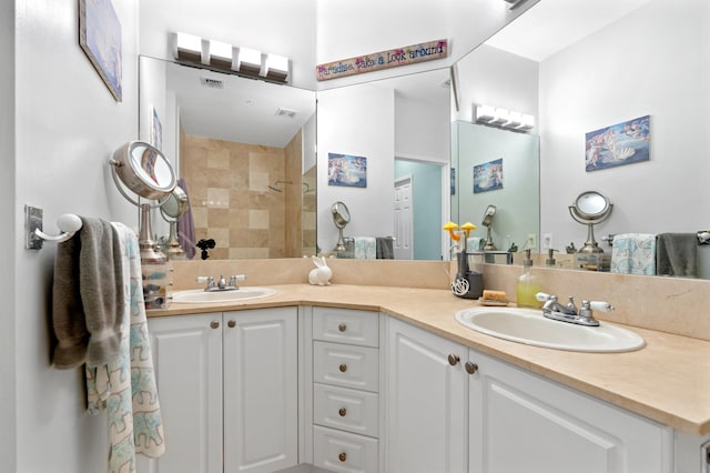 bathroom featuring vanity and a tile shower