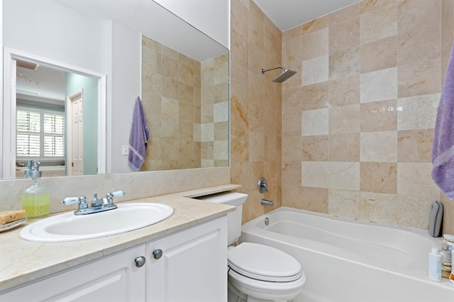 full bathroom featuring toilet, vanity, and tiled shower / bath