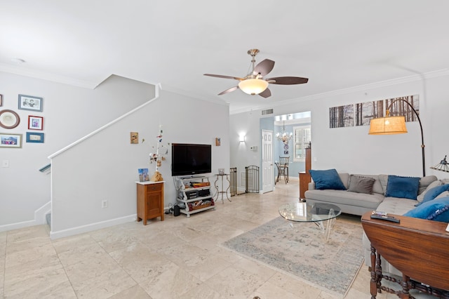 living room with ceiling fan with notable chandelier and crown molding