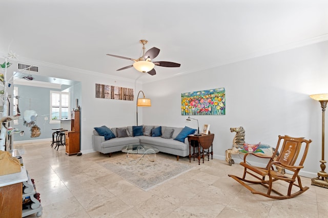 living room featuring ornamental molding and ceiling fan