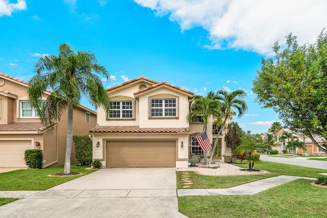 mediterranean / spanish home with a front lawn and a garage