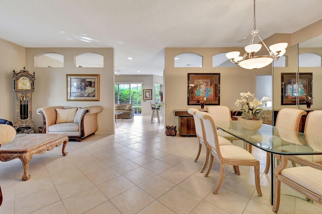 tiled dining space with a notable chandelier