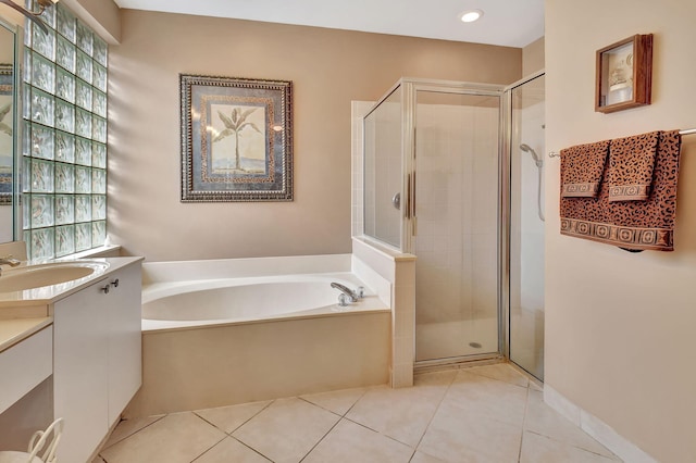 bathroom featuring vanity, plus walk in shower, and tile patterned flooring