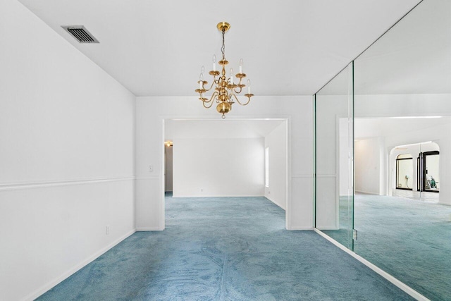 corridor featuring a notable chandelier and carpet flooring