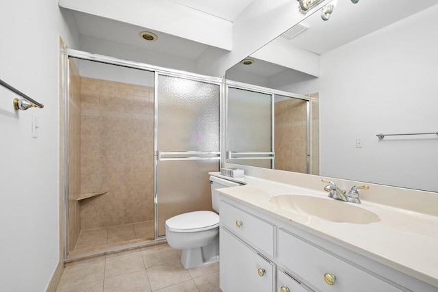 bathroom featuring vanity, toilet, tile patterned floors, and an enclosed shower