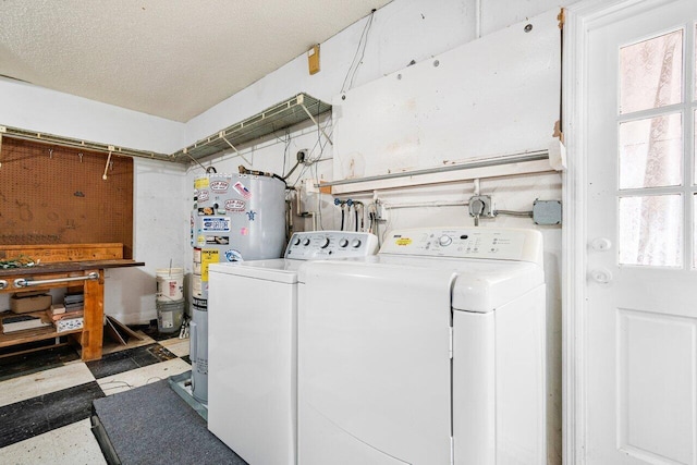 washroom with a wealth of natural light, electric water heater, and separate washer and dryer