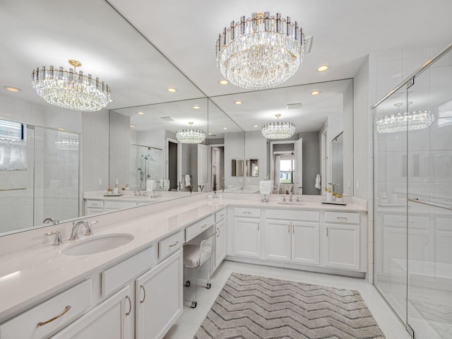 bathroom with vanity, a shower with shower door, and tile patterned flooring